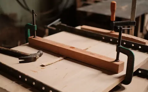 Representative photo: Clamps holding wood on a workbench. Not the exact product; the deal link goes to the actual product.